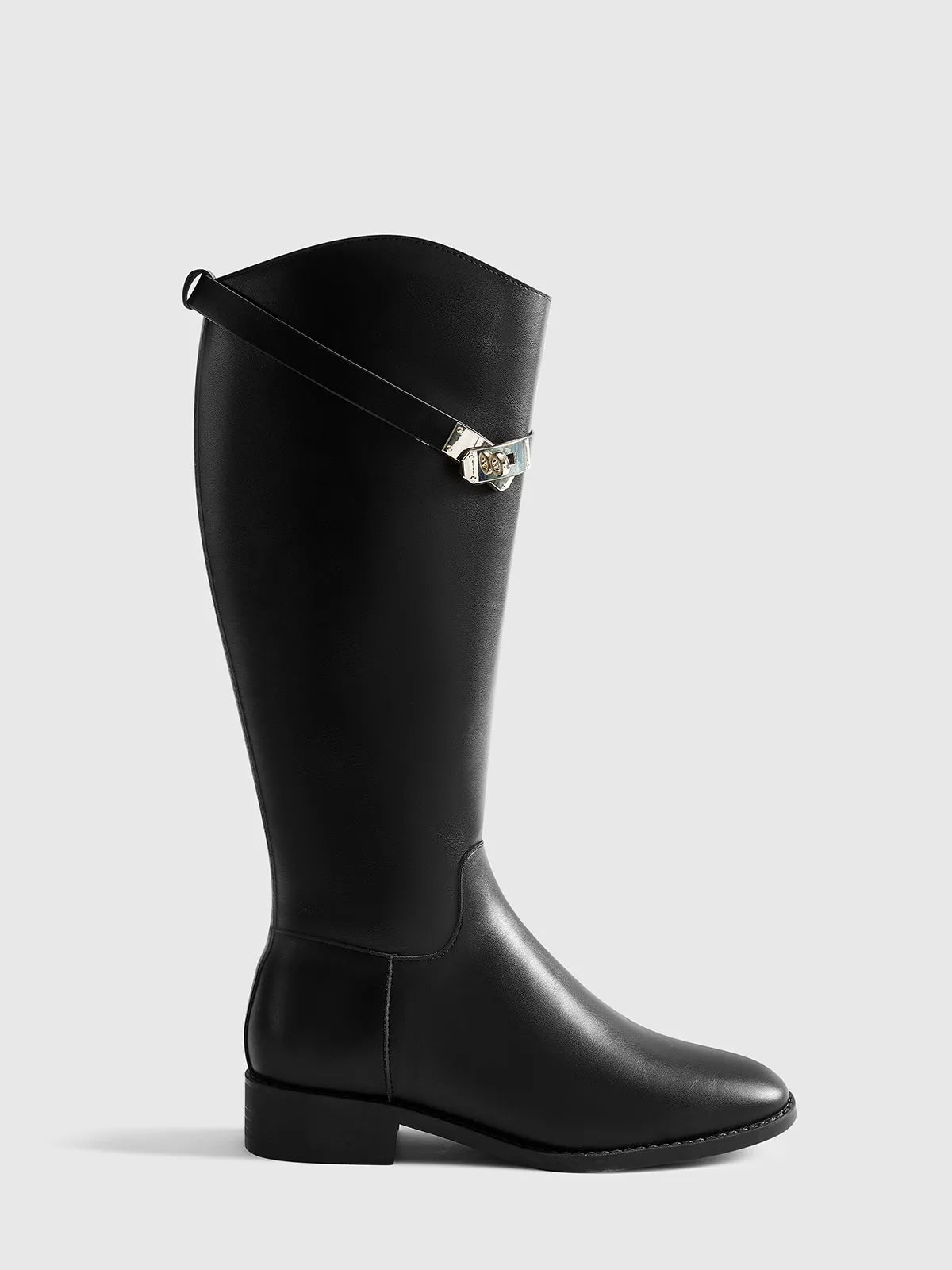 Black knee-high riding-style boot in side profile, showing the low heel and silver-tone buckle.