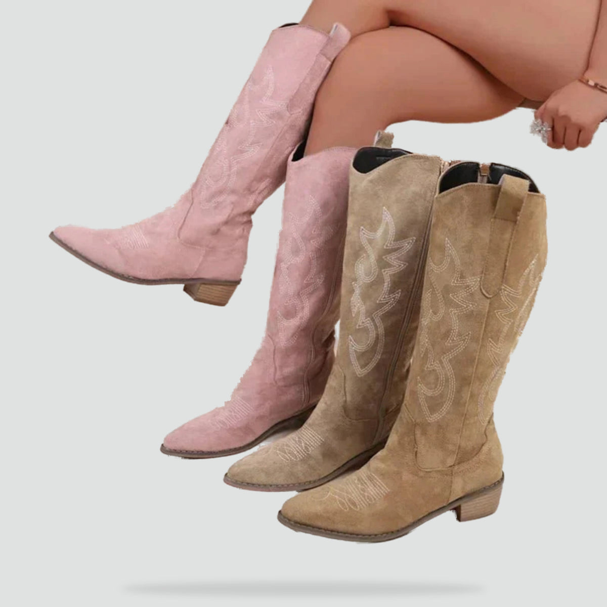 Tan and pink embroidered western boots with pointed toes and low heels